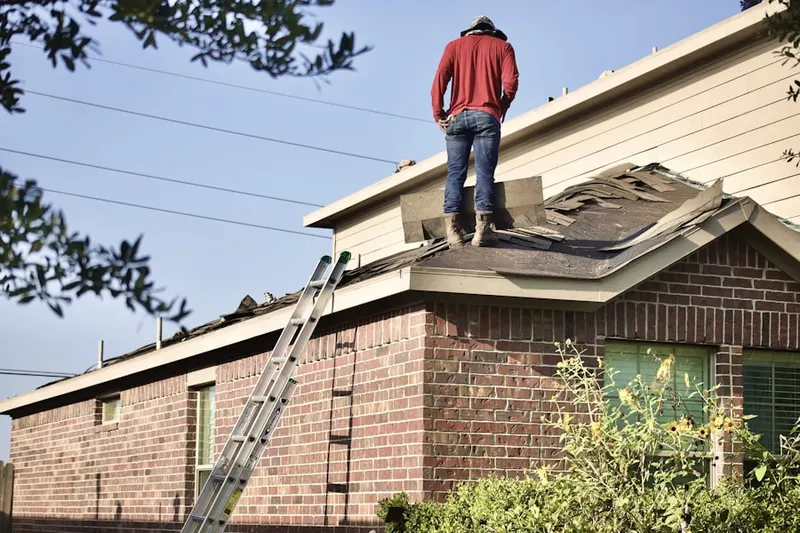 Professional roofer working on a residential roof in Sherwood Park